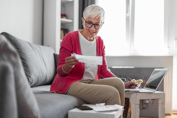 A woman making a qualified charitable distribution (QCD) to a charity approved by the IRS.