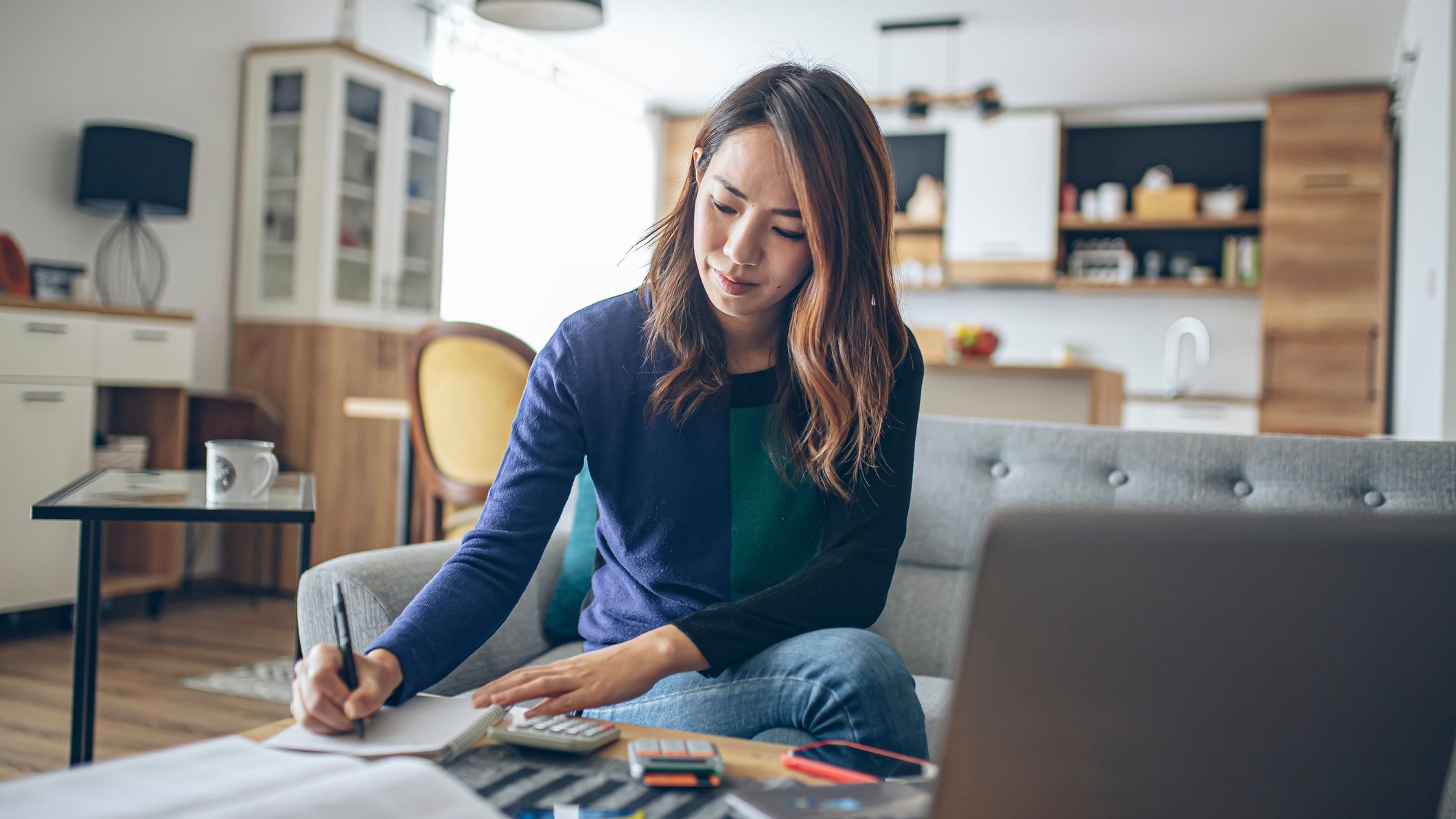 A woman goes over her finances as she prepares to file her tax return. 