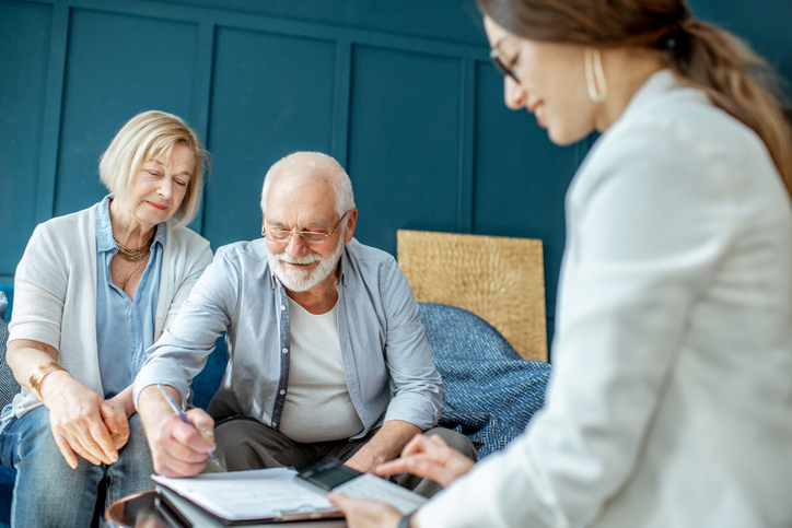 A senior couple meeting with an advisor to review their retirement plan.