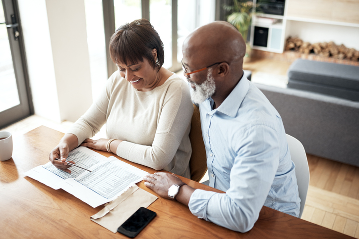 A couple happy after repaying their 401(k) loan. 