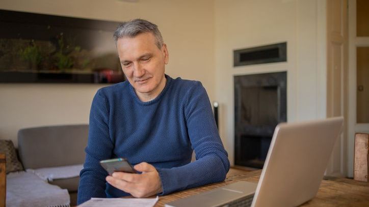 A man looks over his investments to determine what his tax liability could be when he begins taking withdrawals from his portfolio.