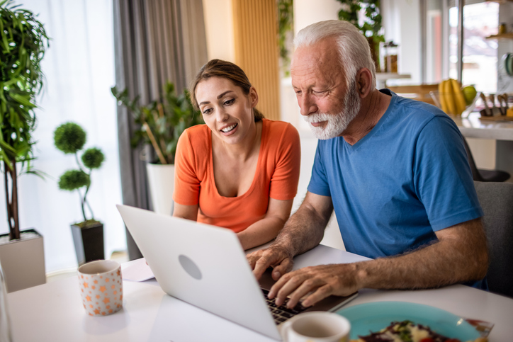 A father researching with his daughter which health insurance premiums are tax deductible.