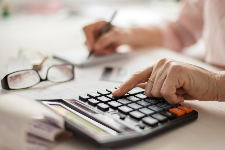 Closeup of a retiree calculating their retirement income.