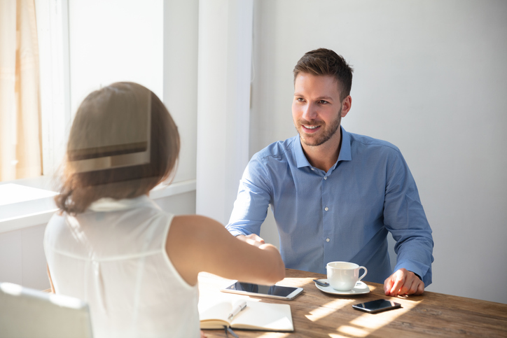 A client meets with a financial advisor to discuss a 401(k) loan.
